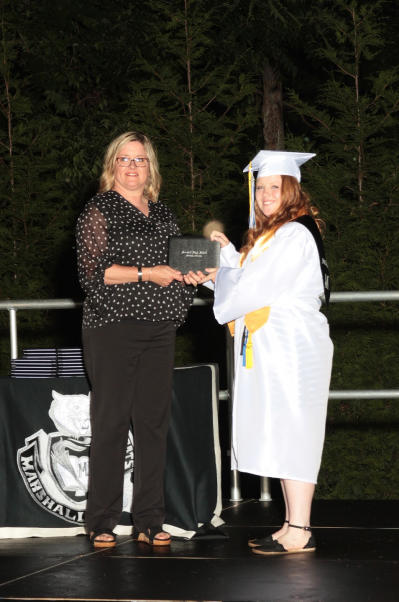 Marshall High School 2020 graduate GleeAnna Housely (right...unless its left I am not looking at it) receives her diploma from her mother, Susan Housely '94, '95, who is also a member of the Searcy County School District School Board. GleeAnna plans to attend the University of Central Arkansas in the fall. 