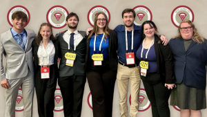 7 students pose after winning first at the Beta Alpha Psi annual conference