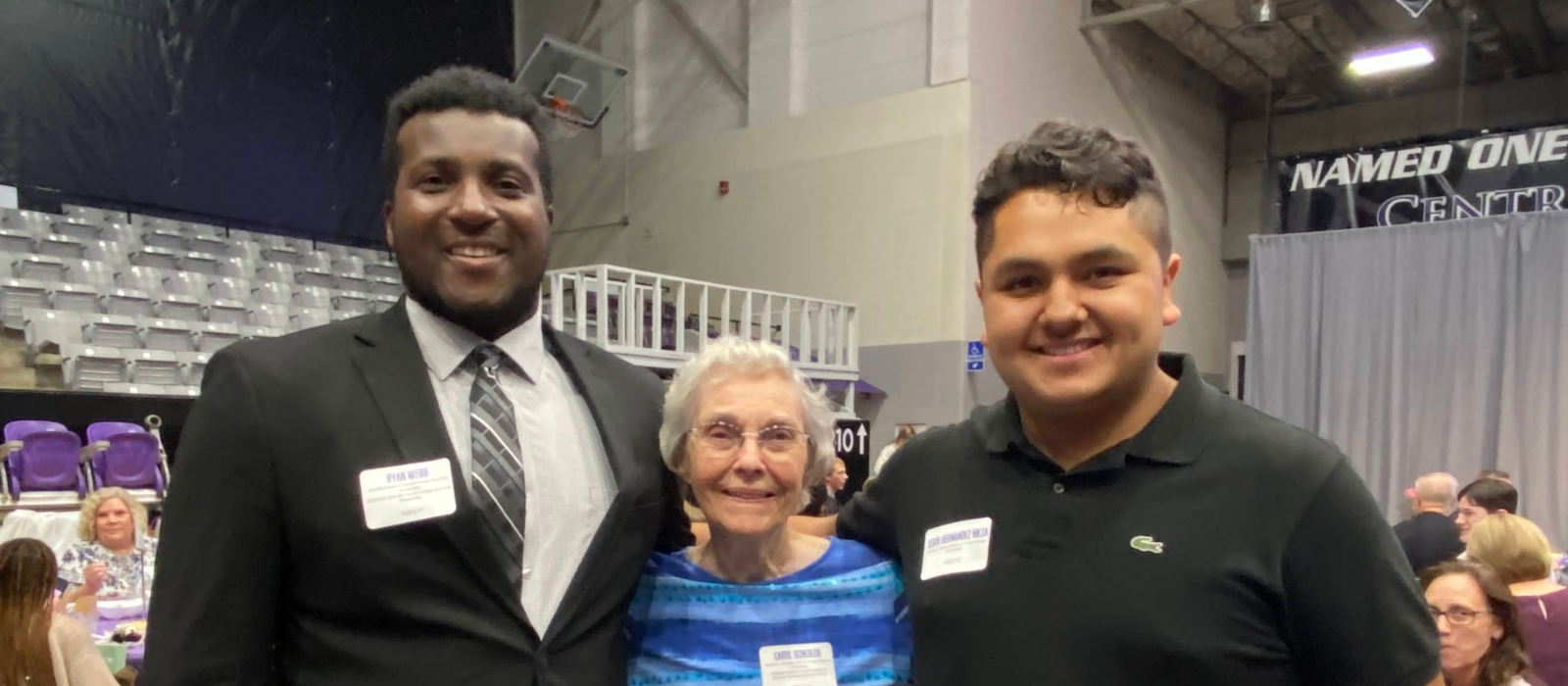 Carol Schedler pictured with two students