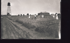 Photo from 1915 shows Arkansas State Normal School students working in the garden on campus. 