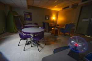 A dark room with comfortable furniture