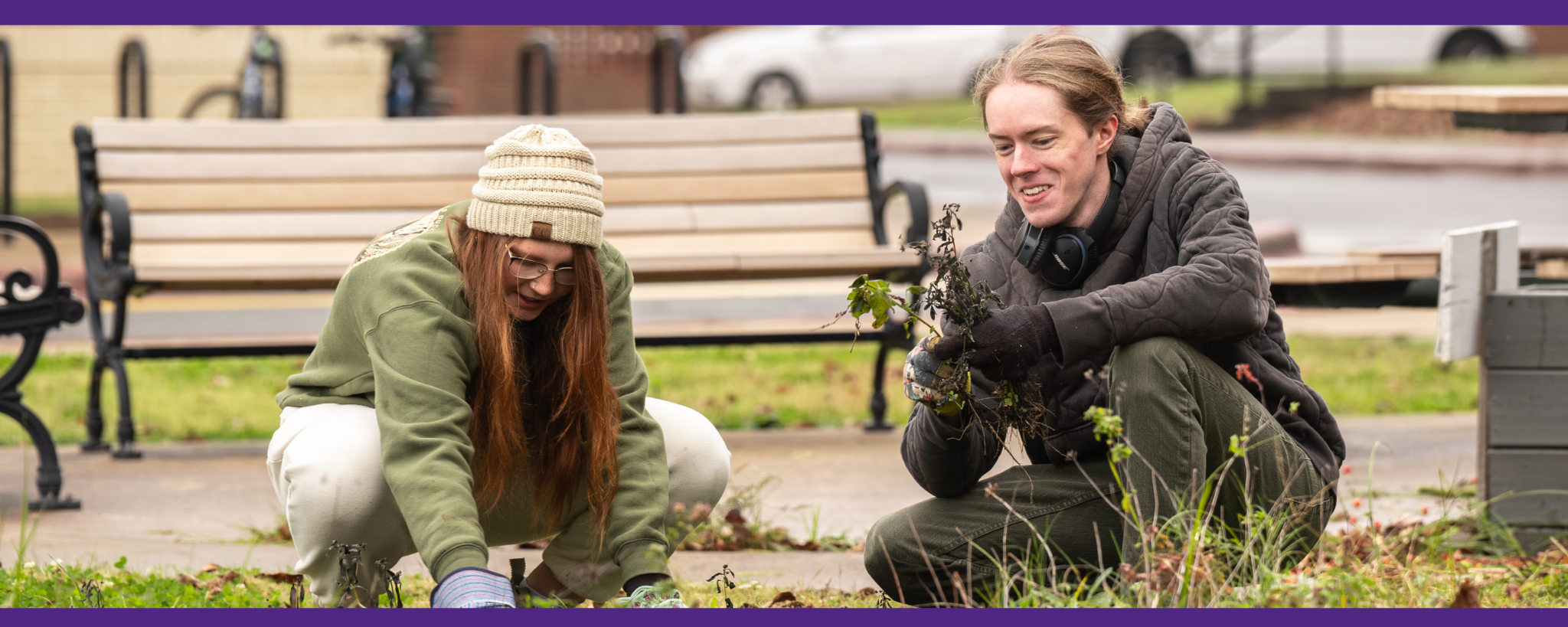 Students pull weeds in the garden outside their residence hall